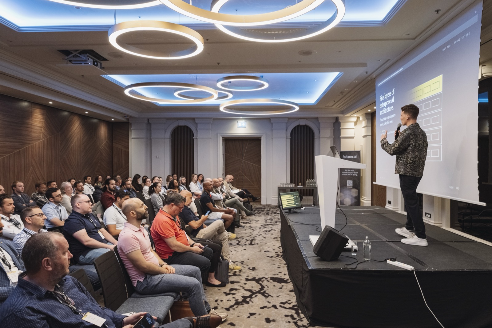 View across the audience towards the stage at the Brixon AI event.