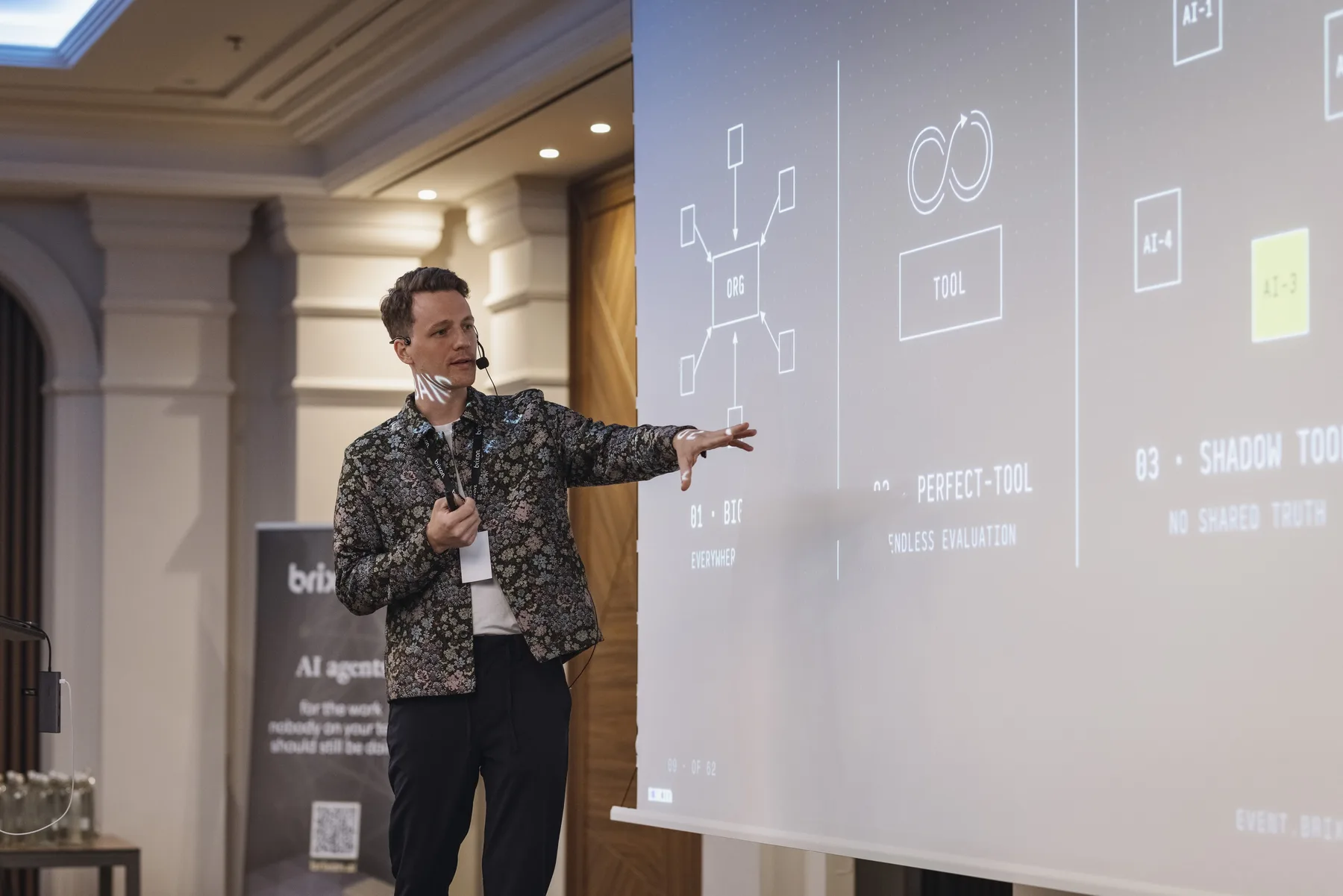 Christoph Sauerborn explaining an agent architecture on a projection screen.