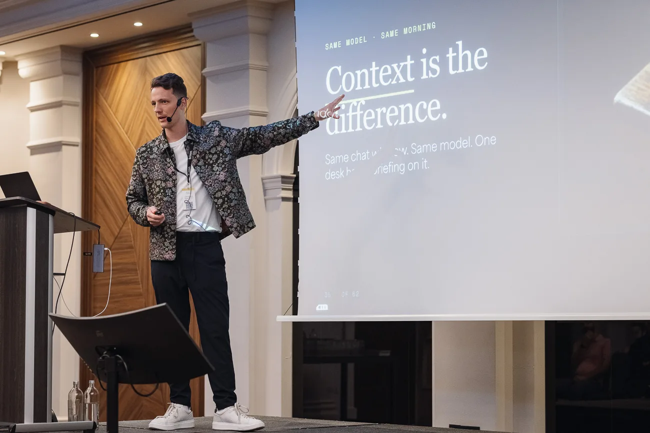Christoph Sauerborn on stage in front of a slide reading Context is the difference.
