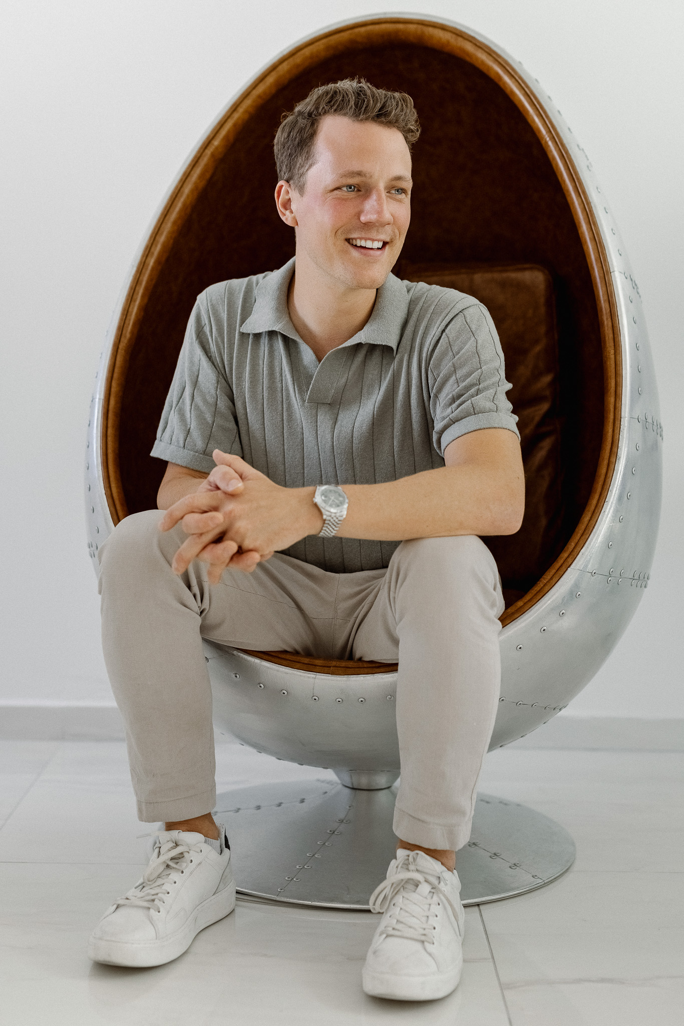 Christoph Sauerborn sitting in a chair and laughing.